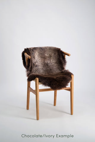 Ecowool Natural Undyed Sheepskin Rugs – Single. Chair with a brown fur cover on a white background