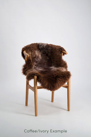 Ecowool Natural Undyed Sheepskin Rugs – Single. Chair with a brown fur cover on a white background