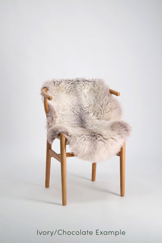 Ecowool Natural Undyed Sheepskin Rugs – Single. Chair with a fur cover on a white background