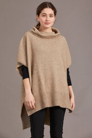 A model wearing a mocha poncho with a cowl neck and a step level hem, standing against a neutral background.