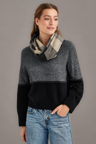 Woman wearing a sepia patterned snood scarf against a neutral background