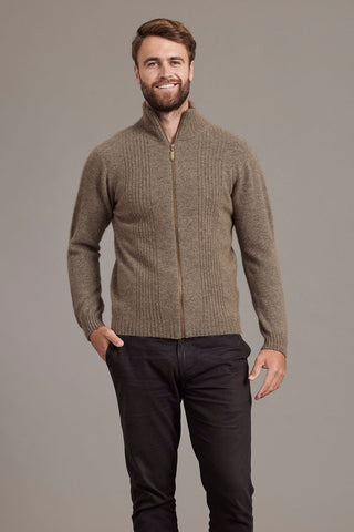 Man wearing a bark brown zip-up sweater against a gray background