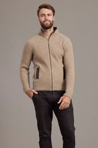 Man wearing a mocha brown knitted jacket against a plain background