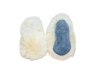 Pair of white sheepskin baby booties on a white background