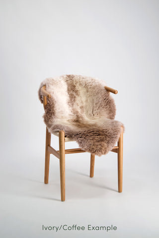 Ecowool Natural Undyed Sheepskin Rugs – Single. Chair with a light brown fur cover on a white background