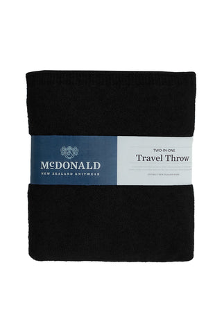 Black travel throw blanket with McDonald New Zealand Knitwear label on a white background